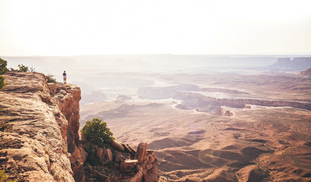 One Person Overlooking Canyonlands National Park in Utah During Sunset